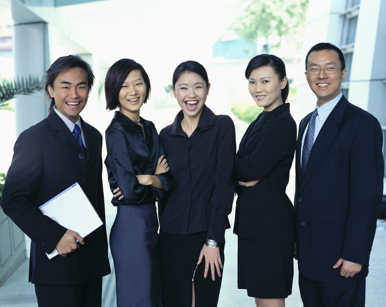 A photograph of a group of happy, smiling business people.